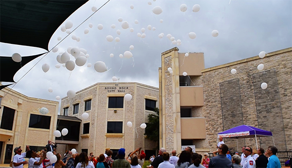 Attendees release white balloons to remember family and friends lost to or suffering from addiction. 