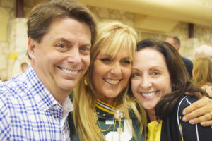 Auction winners Troy and Mary Rodriguez celebrate with Founder Karen Crosby (center).