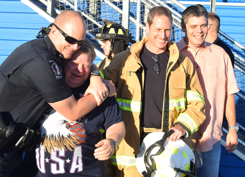 Police Chief Wayne Nero leans on Mayor Dale Ross after the long climb, with Fire Chief John Sullivan and City Manager David Morgan. 