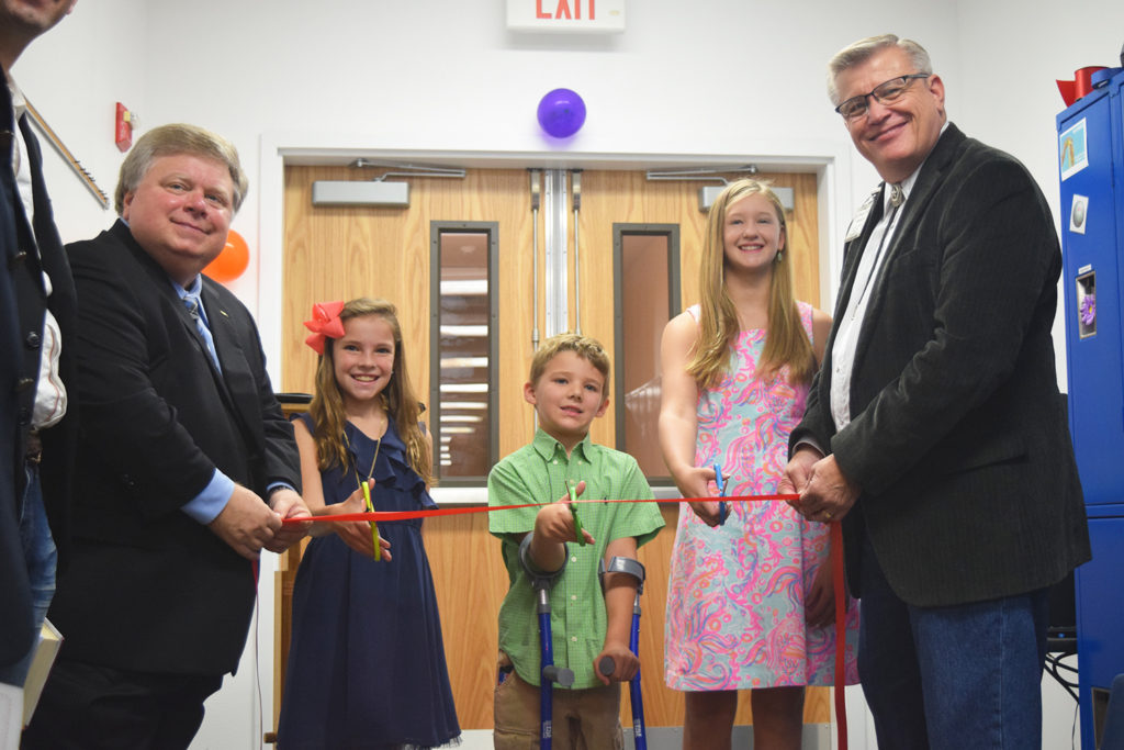 Mayor Dale Ross, Olivia (5th grade), "Super" Cooper (1st grade), and Catherine (8th grade) and Pastor John Davenport prepare to cut the ceremonial ribbon. "This is our future." 