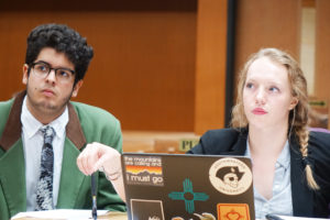 Junior Esteban Woo Kee and Sophomore Co-Captain Samantha Pentecost listen to coach direction prior to arguing the case for the plaintiff. 